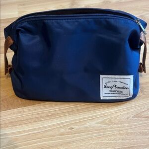 A toiletry bag. Made from durable wipeable  materials with interior lining,